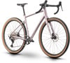 Ein rosafarbenes Gravelbike mit braunen Reifen und Scheibenbremsen.