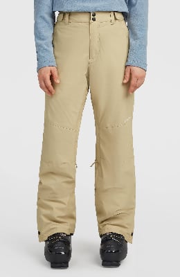 Eine beige Skihose mit schwarzen Schnallen und einer blauen Jacke. Eine beige Skihose mit schwarzen Schnallen und einer blauen Jacke.