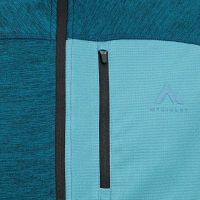 Detail einer Fleecejacke mit McKinley-Logo und Reißverschlusstasche.