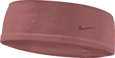 Ein rosafarbener Nike-Schweißband mit Swoosh-Logo an der Seite. Ein rosafarbener Nike-Schweißband mit Swoosh-Logo an der Seite.