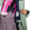 Kinder-Winterjacke mit Latzhose und rosa Fleeceweste.