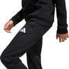 Schwarzer Jogginganzug mit weißem Adidas-Logo am Bein.