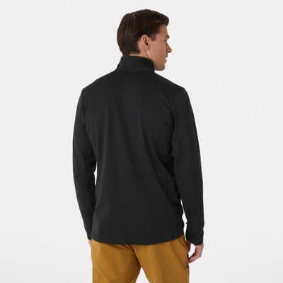 Ein Mann in einem schwarzen Rollkragenpullover und braunen Hosen posiert mit dem Rücken zur Kamera. Ein Mann in einem schwarzen Rollkragenpullover und braunen Hosen posiert mit dem Rücken zur Kamera.
