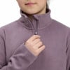 Ein Mädchen zupft am Reißverschluss eines violetten Fleece-Pullover mit hohem Kragen.