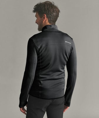 Mann in schwarzer Fleecejacke mit ORTOVOX-Logo auf dem Rücken. Mann in schwarzer Fleecejacke mit ORTOVOX-Logo auf dem Rücken.